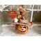 This image shows a Halloween witch decoration. It is made from a real dried gourd. Her name is Beatrice and has an orange witch hat.
